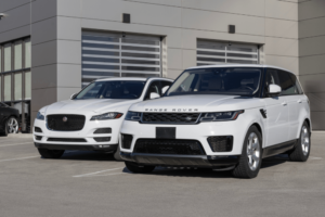 luxury vehicle, european auto repair in Englewood, CO at AutoImports of Denver. A white Jaguar SUV and a white Range Rover parked side by side.