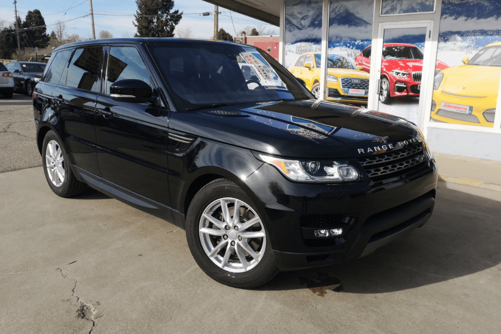 land rover reliability, european auto repair in Englewood, CO at AutoImports of Denver. Black Range Rover parked outside an auto repair shop.