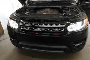 land rover repair in Denver, European auto repair in Englewood, CO at AutoImports of Denver. Image of black Land Rover SUV being serviced inside a professional repair shop.